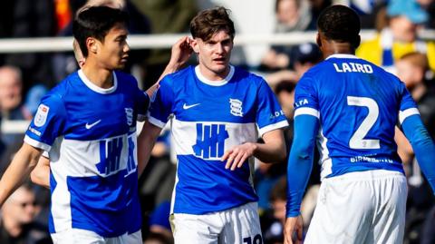 Taylor Gardner-Hickman celebrates his goal with Paik Seung-Ho and Ethan Laird