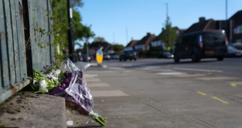 A bunch of flowers left at the scene of the crash