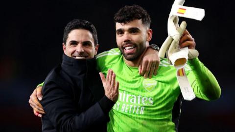 Mikel Arteta, Manager of Arsenal, and David Raya of Arsenal embrace at full-time after victory in the penalty shoot out following the UEFA Champions League 2023/24 round of 16 second leg match between Arsenal FC and FC Porto at Emirates Stadium on March 12, 2024