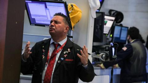 Traders work on the floor of the New York Stock Exchange (NYSE) in New York, U.S.,