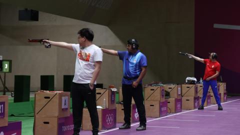 Wei Pang, Javad Foroughi and Damir Mikec are shooting at targets that are out of sight of the camera