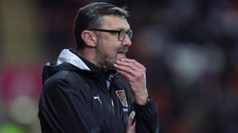 Interim boss Ian Sampson watching from the touchline as Northampton Town play Rotherham United