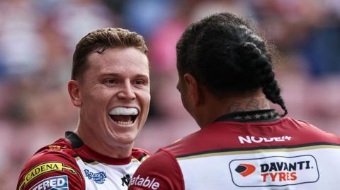 Wigan Warriors' Jai Field celebrates with Patrick Mago after scoring a try.