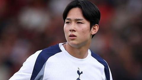 Yang Min-hyeok standing with his arms on his hips during a pre-season match for Tottenham