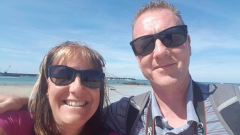 Katie Gatt and Paul taking a selfie on the beach