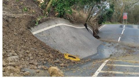 Extremely damaged road, cracked and uneven road