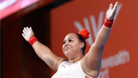 Emily Campbell raises her arms in celebration