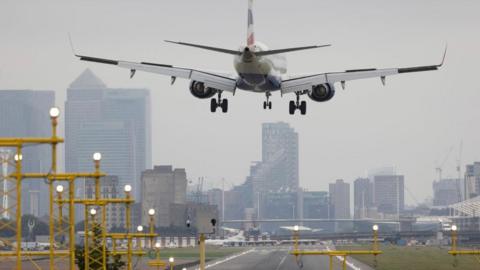 A plane lands at a London airport.