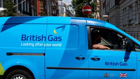 An employee in a British Gas van