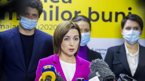Presidential candidate Maia Sandu (C) speaks to media after polling stations closed in the second round of presidential elections in Chisinau, Moldova, 15 November 2020