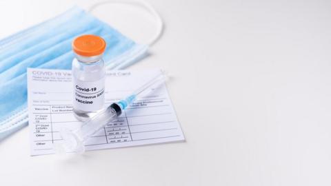 Covid-19 vaccine and syringe