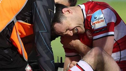Tomos Williams winces in pain at Gloucester