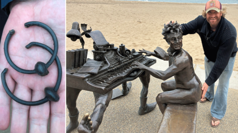 Sculptor Nick Elphick with the statue of a naked Terry Jones playing a piano