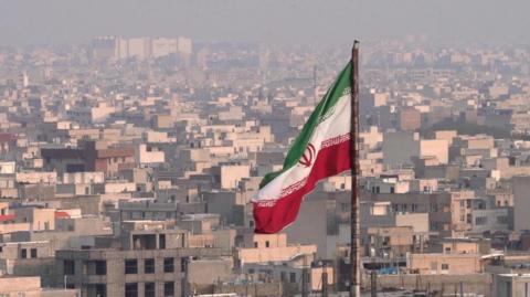 iran flag over city