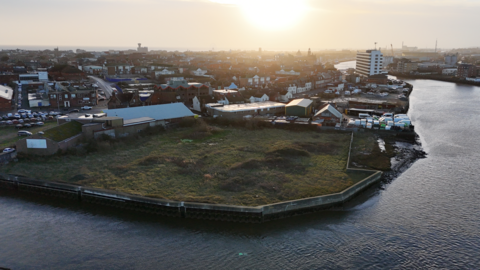 An aerial view of derelict land at North Quay in Great Yarmouth, next to the river.