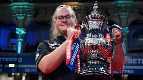 Beau Greaves celebrates winning the Women's Matchplay at Winter Gardens in Blackpool by lifting the silver trophy aloft