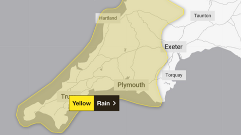 A screenshot of the Met Office website with a 2D map of the south west, including Devon, Cornwall and Somerset, with a yellow overlay warning of rain in the region.