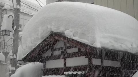 A building with thick snow on the roof