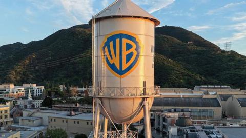 In an aerial view, the Warner Bros. logo is displayed on the water tower at Warner Bros. Studio in Burbank, California.