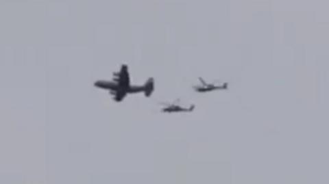 A still of a video showing what appears to be a US plane accompanied by two helicopters flying over southern Iran