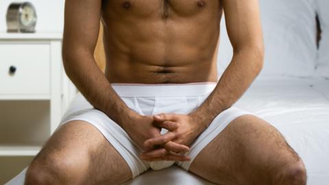 Man sitting on edge of bed