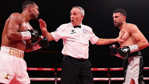 The referee stands in between Harlem Eubank and Nurali Erdogan 