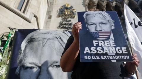 Placards supporting Julian Assange outside courthouse