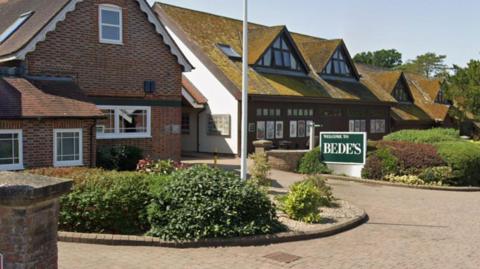 Street view images of houses with small hedges in front of them