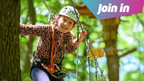a girl on a treetop adventure park.