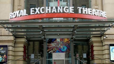 Entrance to the Royal Exchange theatre in a Georgian stone building, with name sign above