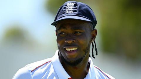 Jofra Archer smiling during an England warm-up at Lilac Hill