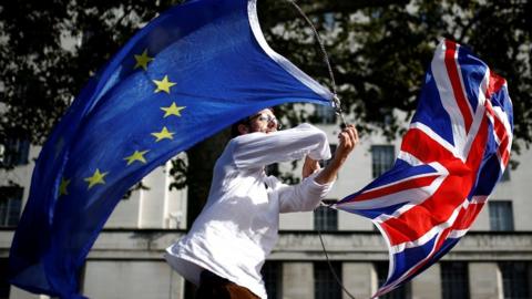 A man waves EU and union flags at Westminster in London