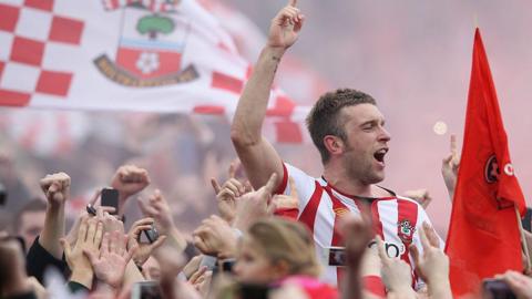Rickie Lambert celebrates during a pitch invsion as Southampton win promotion