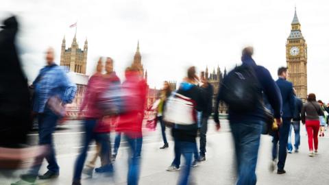 People walking in front of the Houses of Parliament in London