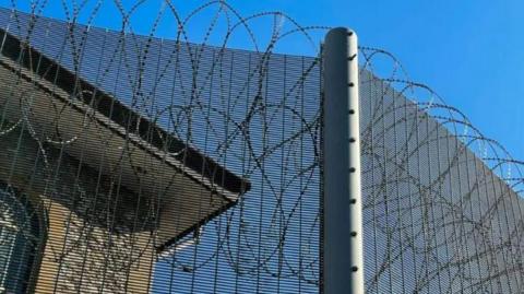 Barbed wire surrounding a prison