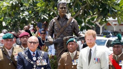 Britain"s Prince Harry and Fiji"s President Jioji Konrote pose in front of a new statue commemorating Sergeant Talaiasi Labalaba