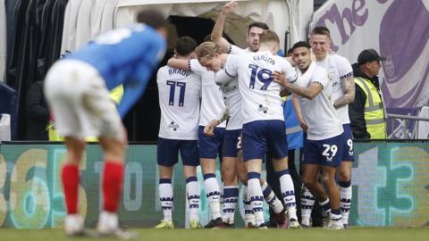 Preston players celebrate a late winner over Portsmouth