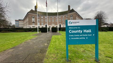 Photo of County Hall in Taunton with the welcome sign in the forefront