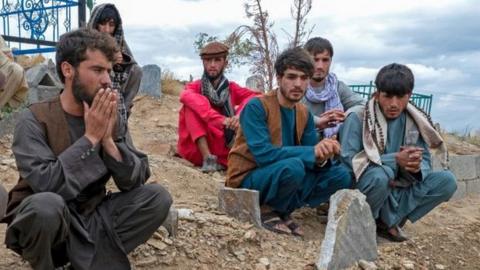 Afghans pray at burial ceremony for blast victims - 18th August