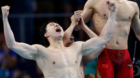 Qin Haiyang of Team China celebrates after the team's win at 4x100m medley relay