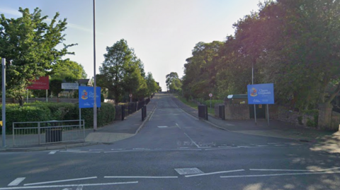 The entrance to a school driveway from the main road