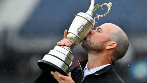 Open champion Brian Harman kissing the Claret Jug