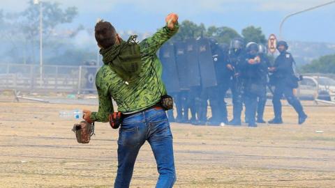 A supporter of former Brazilian president, Jair Bolsonaro, throws stones at security forces during a riot on 8 January