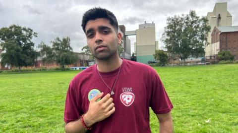 Sayhan Sheikh with dark hair wearing a red t-shirt at Wellingborough embankment