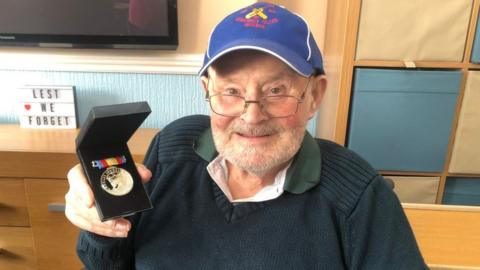 Picture of Mr Copeland with his medal