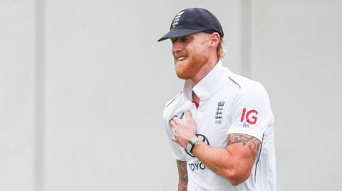 England captain Ben Stokes prods between his right shoulder