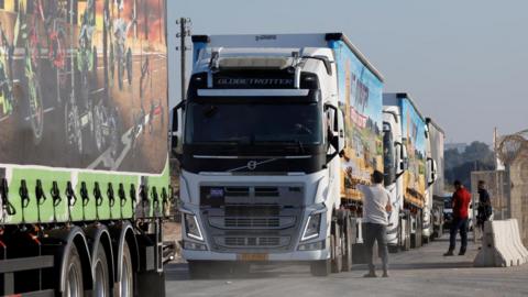 Trucks carrying humanitarian aid destined for the Gaza Strip queue at the Kerem Shalom crossing in southern Israel.