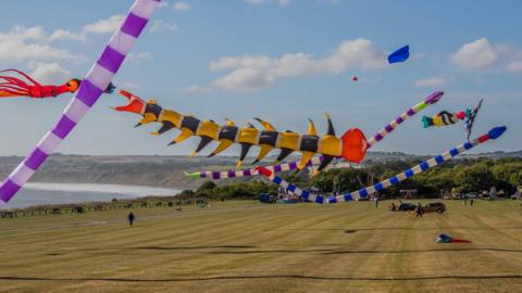 Colourful kites flying above Filey Brigg Country Park