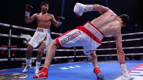 Josh Kelly looks on as Bakhram Murtazaliev falls