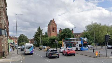 Google street view of Smithdown Road with cars and a bus driving through it